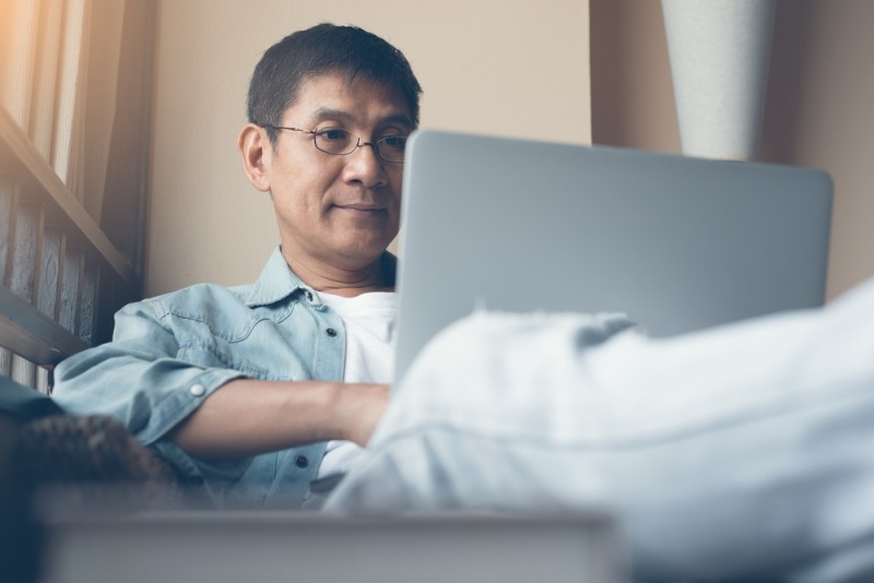An options trader reviews alerts on his laptop computer.